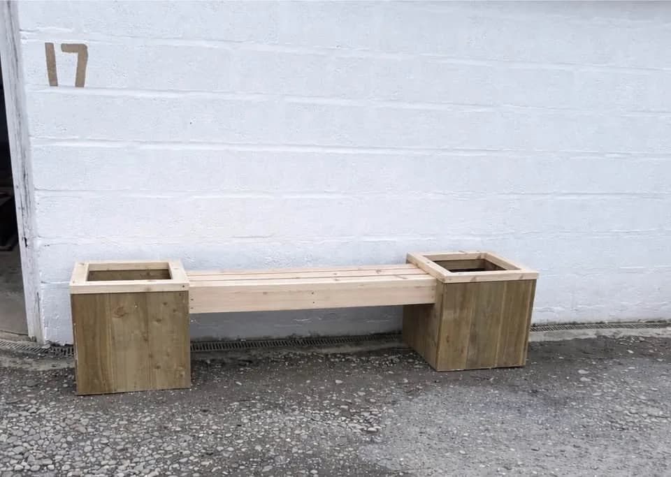 Timber bench joining two square planter boxes